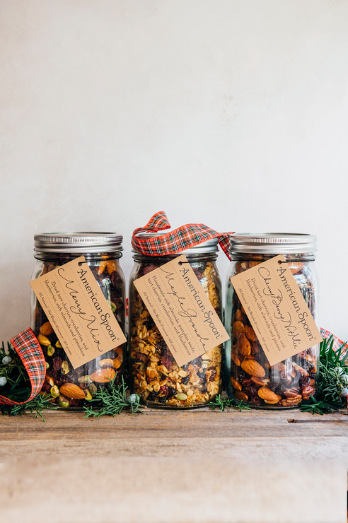 Load image into Gallery viewer, Jars of the Merry Mix, Maple Granola and Cherry Berry Nut Mix surrounded by greenery
